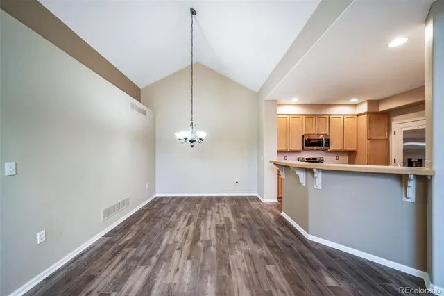 a kitchen with stainless steel appliances a stove refrigerator sink and microwave