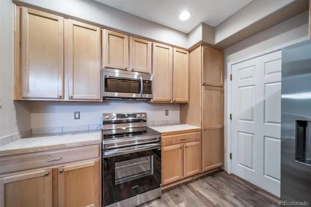 a kitchen with a sink refrigerator and window