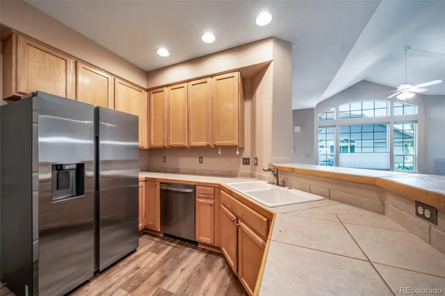 a kitchen with a sink window and cabinets