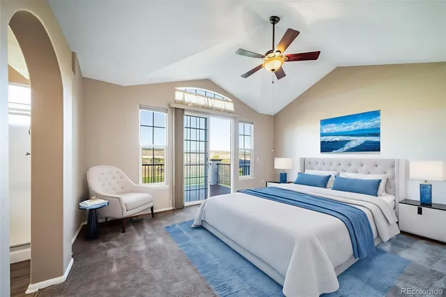 an empty room with windows and chandelier fan