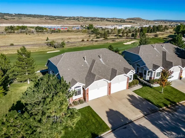 an aerial view of a house with a yard and lake view