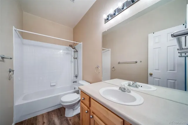 an empty room with chandelier fan and windows