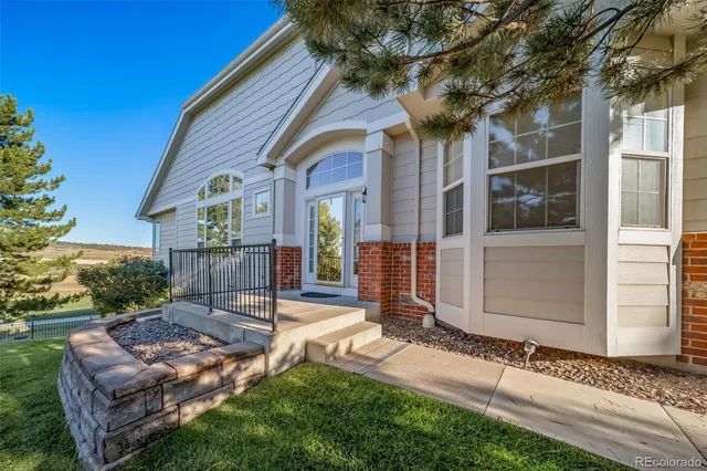 a view of a house with a yard and sitting area