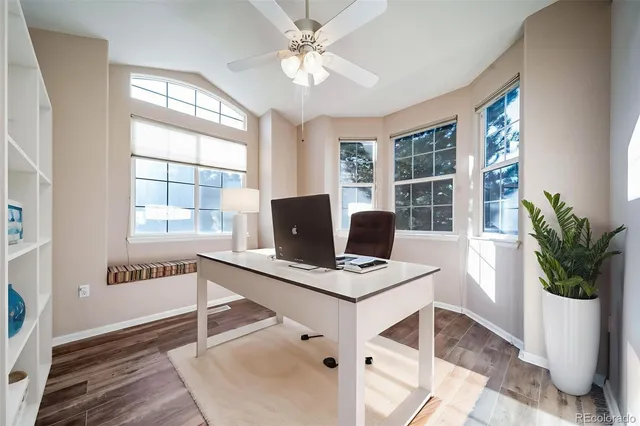 a view of workspace with wooden floor windows