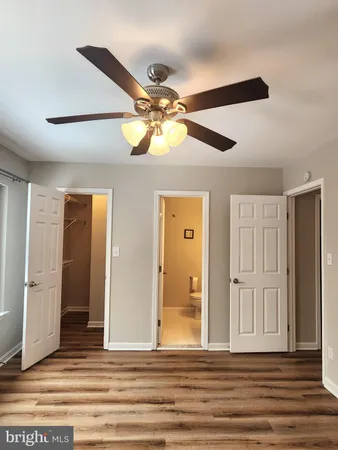 a view of a livingroom with a space & a ceiling fan