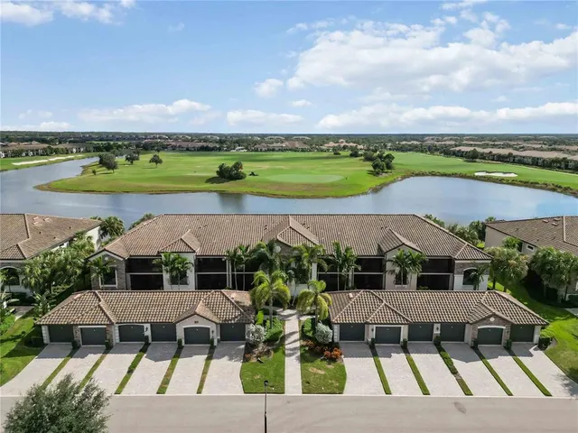 an aerial view of a house with a garden and lake view
