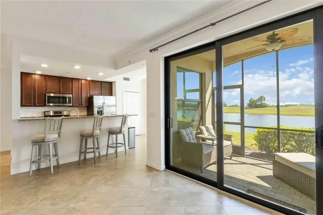 a view of kitchen with microwave and refrigerator