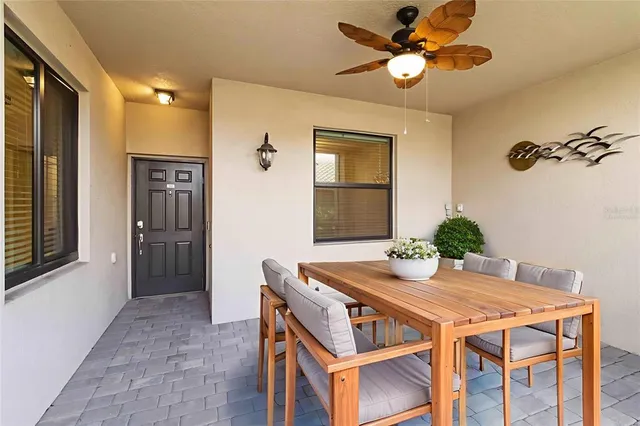 a view of a dining room with furniture and a chandelier fan