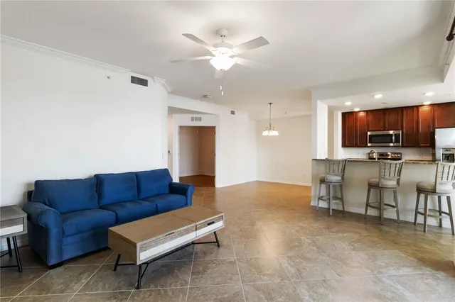 a living room with furniture and kitchen view