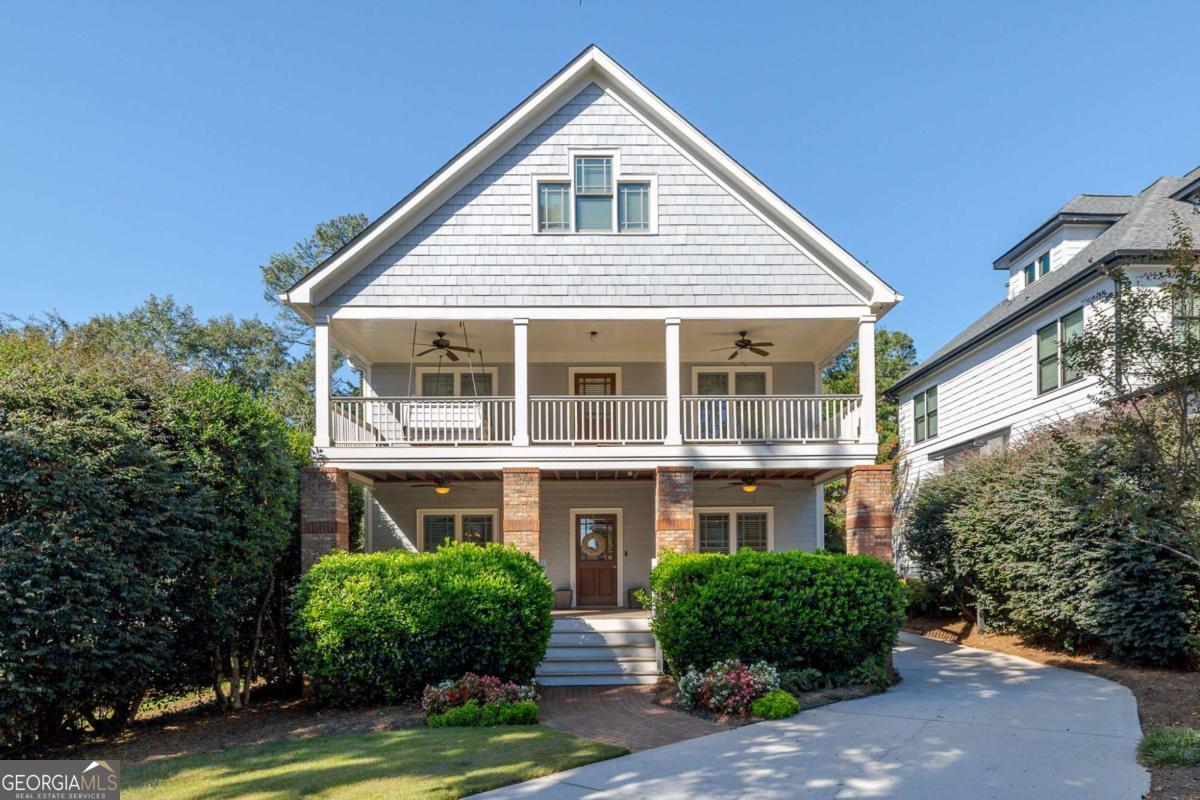 4492 Oakdale Road Southeast Smyrna, GA 30080 - Photo 1 of 37 a front view of a house with a yard and potted plants