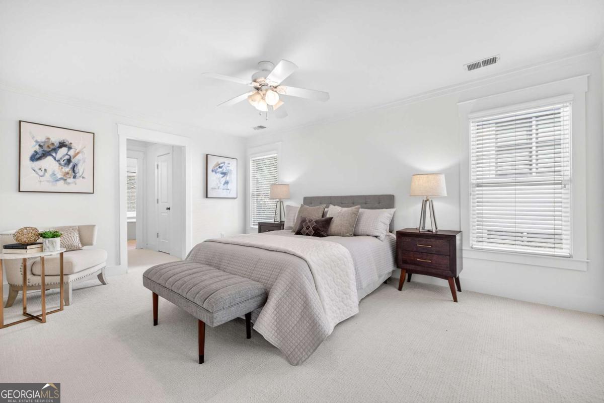 4492 Oakdale Road Southeast Smyrna, GA 30080 - Photo 14 of 37 a spacious bedroom with a bed a table and chair
