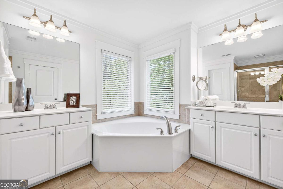 4492 Oakdale Road Southeast Smyrna, GA 30080 - Photo 17 of 37 a bathroom with a tub sink and mirror