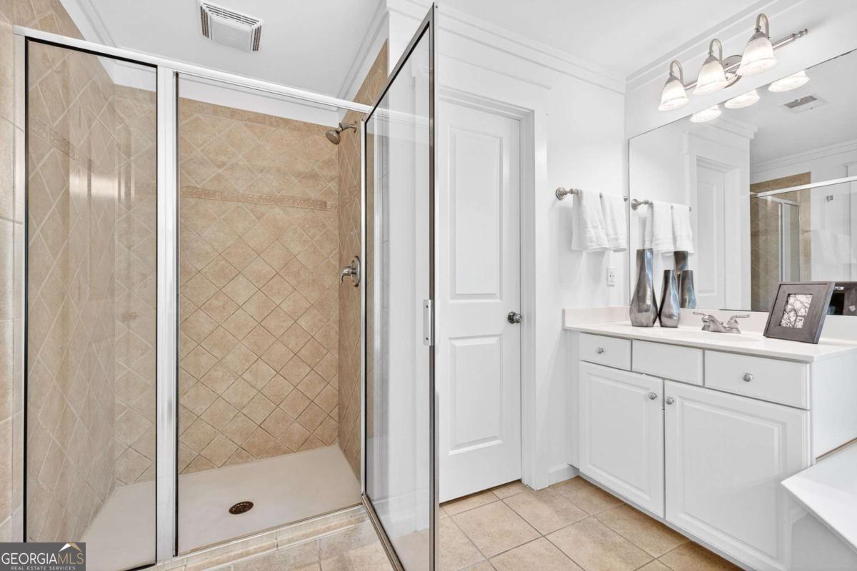 4492 Oakdale Road Southeast Smyrna, GA 30080 - Photo 18 of 37 a bathroom with a shower sink and mirror
