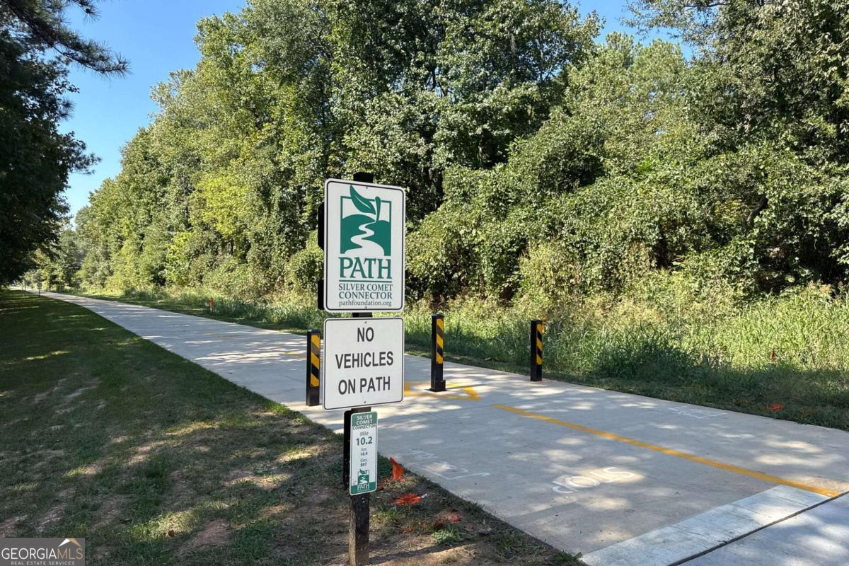 4492 Oakdale Road Southeast Smyrna, GA 30080 - Photo 33 of 37 a sign board with a yard and lake view in back