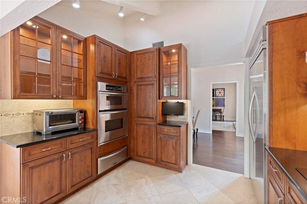 24741 Eldamar Avenue Lake Forest, CA 92630 - Photo 13 of 67 a kitchen with stainless steel appliances granite countertop a refrigerator and cabinets