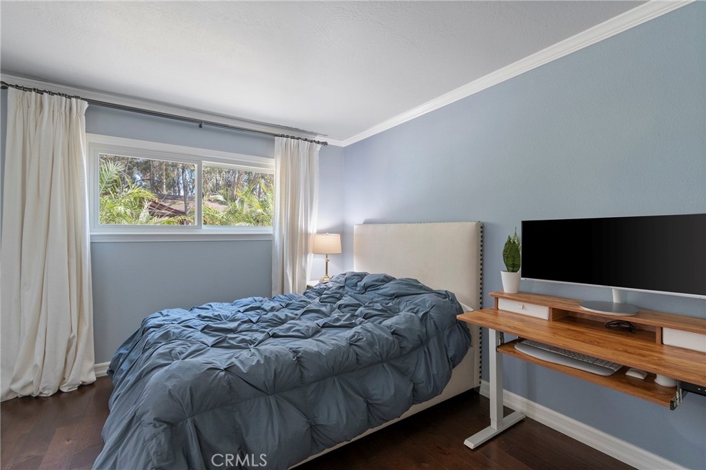 24741 Eldamar Avenue Lake Forest, CA 92630 - Photo 21 of 67 a bedroom with a bed and a flat screen tv