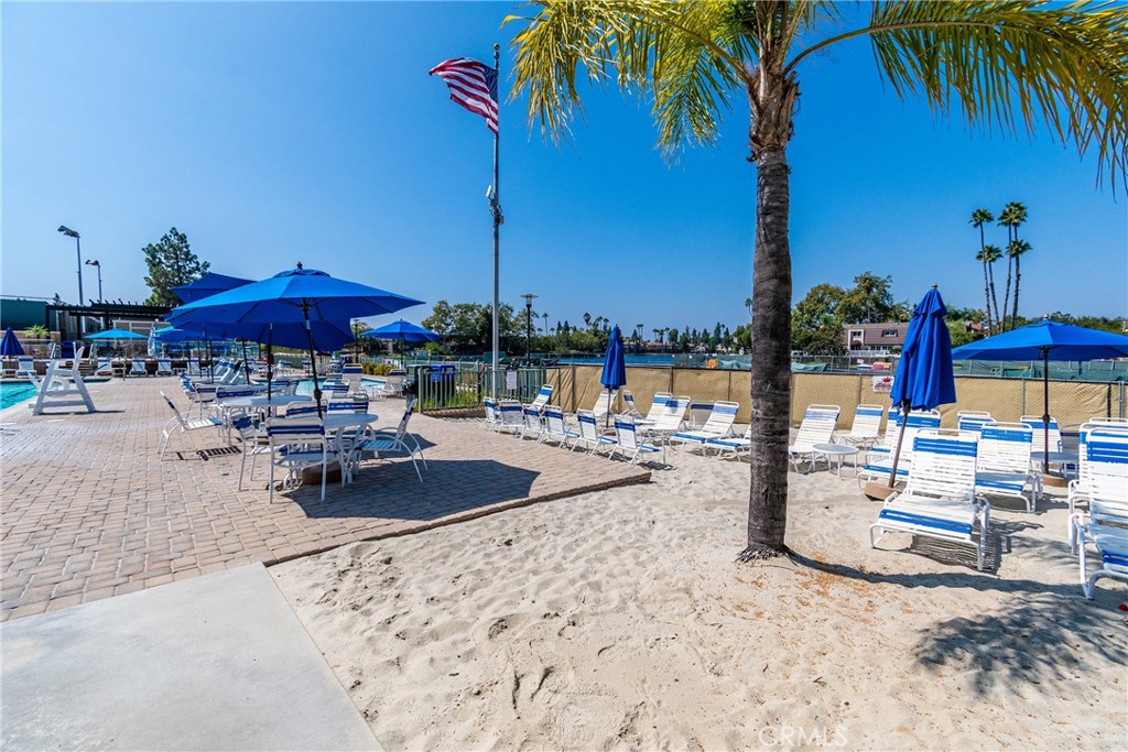 24741 Eldamar Avenue Lake Forest, CA 92630 - Photo 40 of 67 a view of a swimming pool with a table and chairs under an umbrella