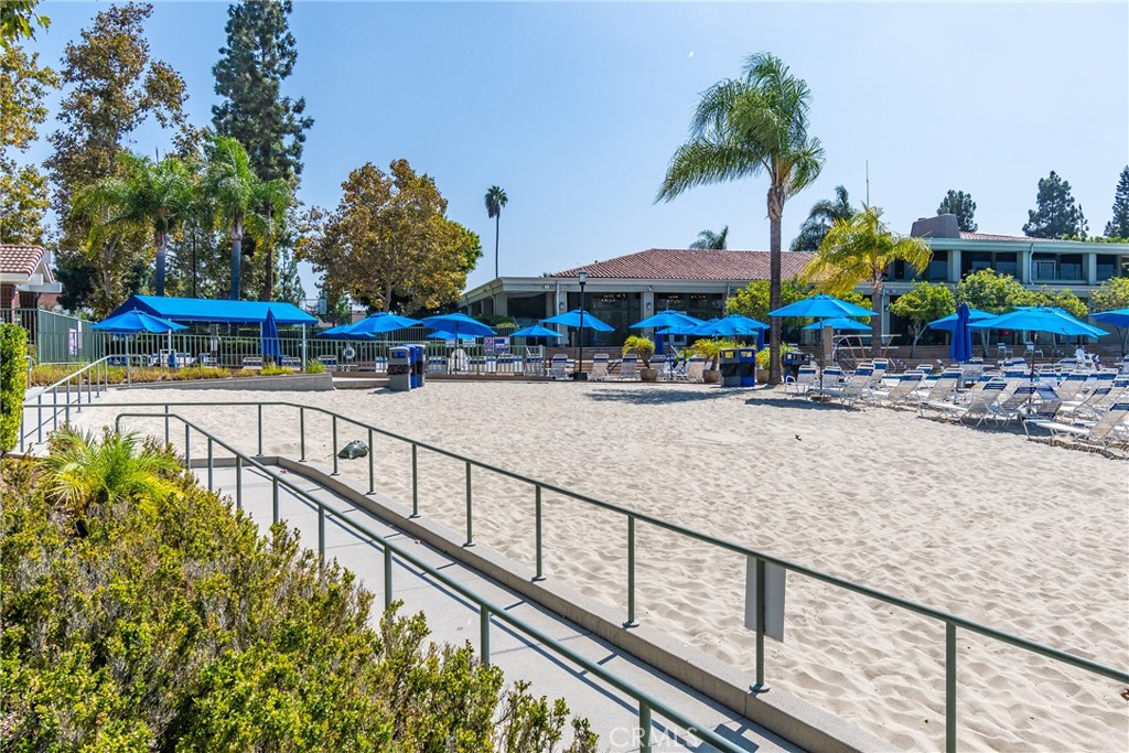 24741 Eldamar Avenue Lake Forest, CA 92630 - Photo 43 of 67 a view of a swimming pool with a lawn chairs under an umbrella