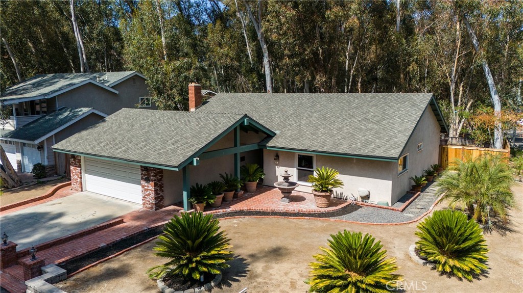 24741 Eldamar Avenue Lake Forest, CA 92630 - Photo 53 of 67 a view of a patio with table and chairs potted plants with wooden floor and large tree