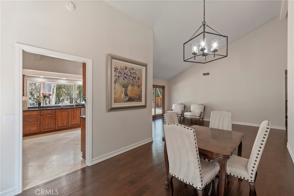 24741 Eldamar Avenue Lake Forest, CA 92630 - Photo 8 of 67 a view of a dining room with furniture wooden floor and chandelier