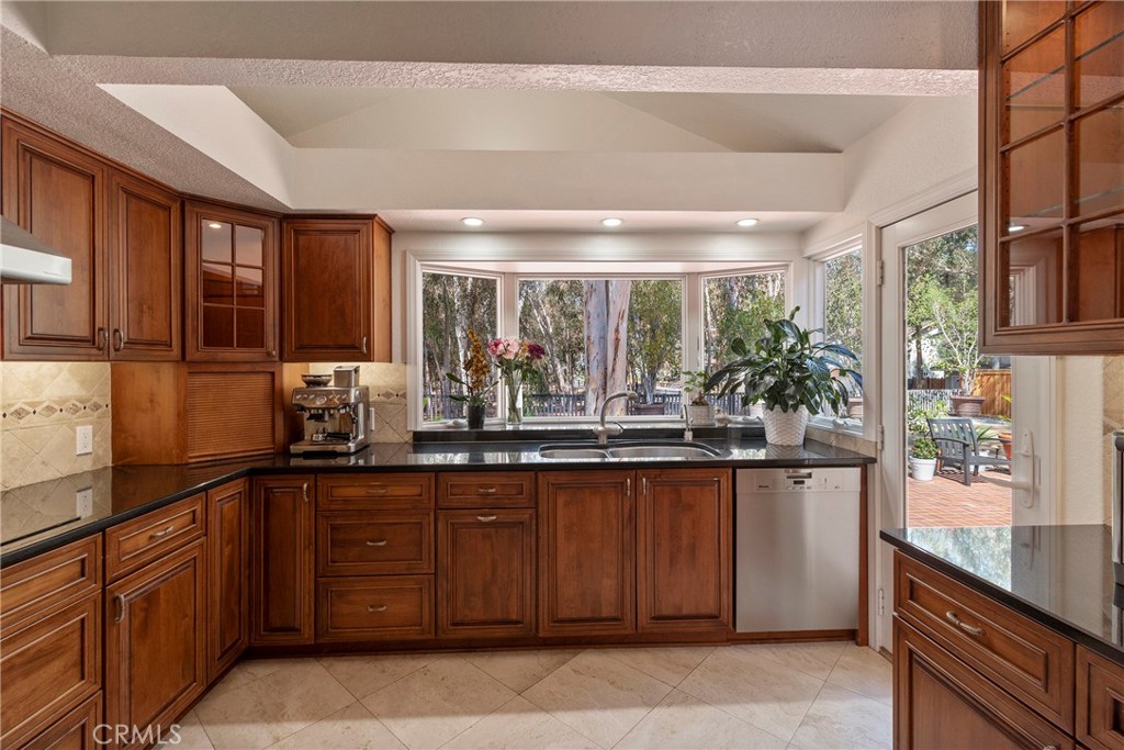 24741 Eldamar Avenue Lake Forest, CA 92630 - Photo 10 of 67 a kitchen with a sink and wooden cabinets