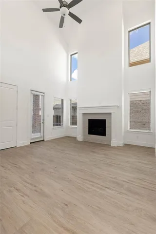 a view of an empty room with a fireplace and a window