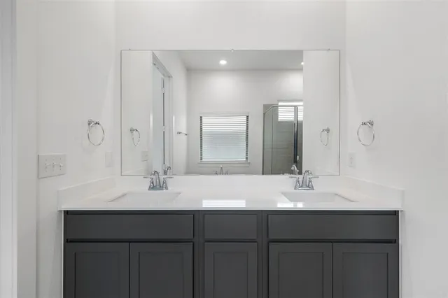 a bathroom with a sink vanity and mirror