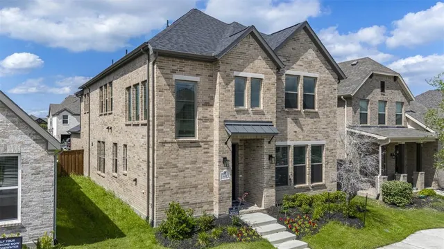 a view of a big house with wooden fence