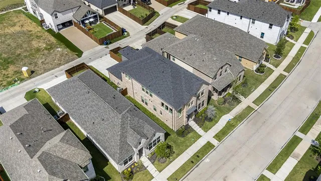an aerial view of residential houses with outdoor space and street view