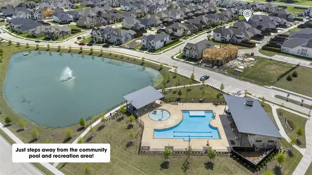 an aerial view of a house with garden space and a car parked