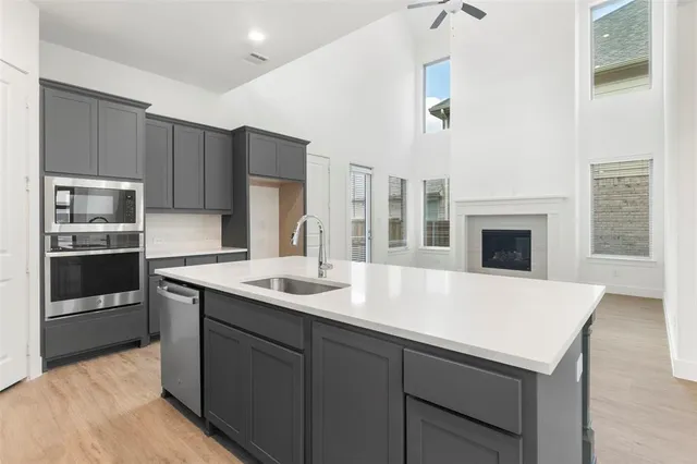 a kitchen with a sink refrigerator and microwave