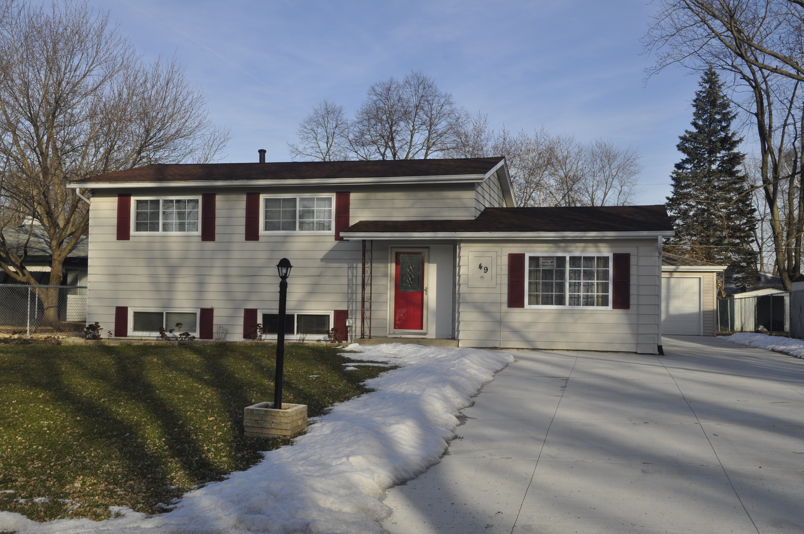 49 Pueblo Road Montgomery, IL 60538 - Photo 1 of 35 a front view of a house with a garden