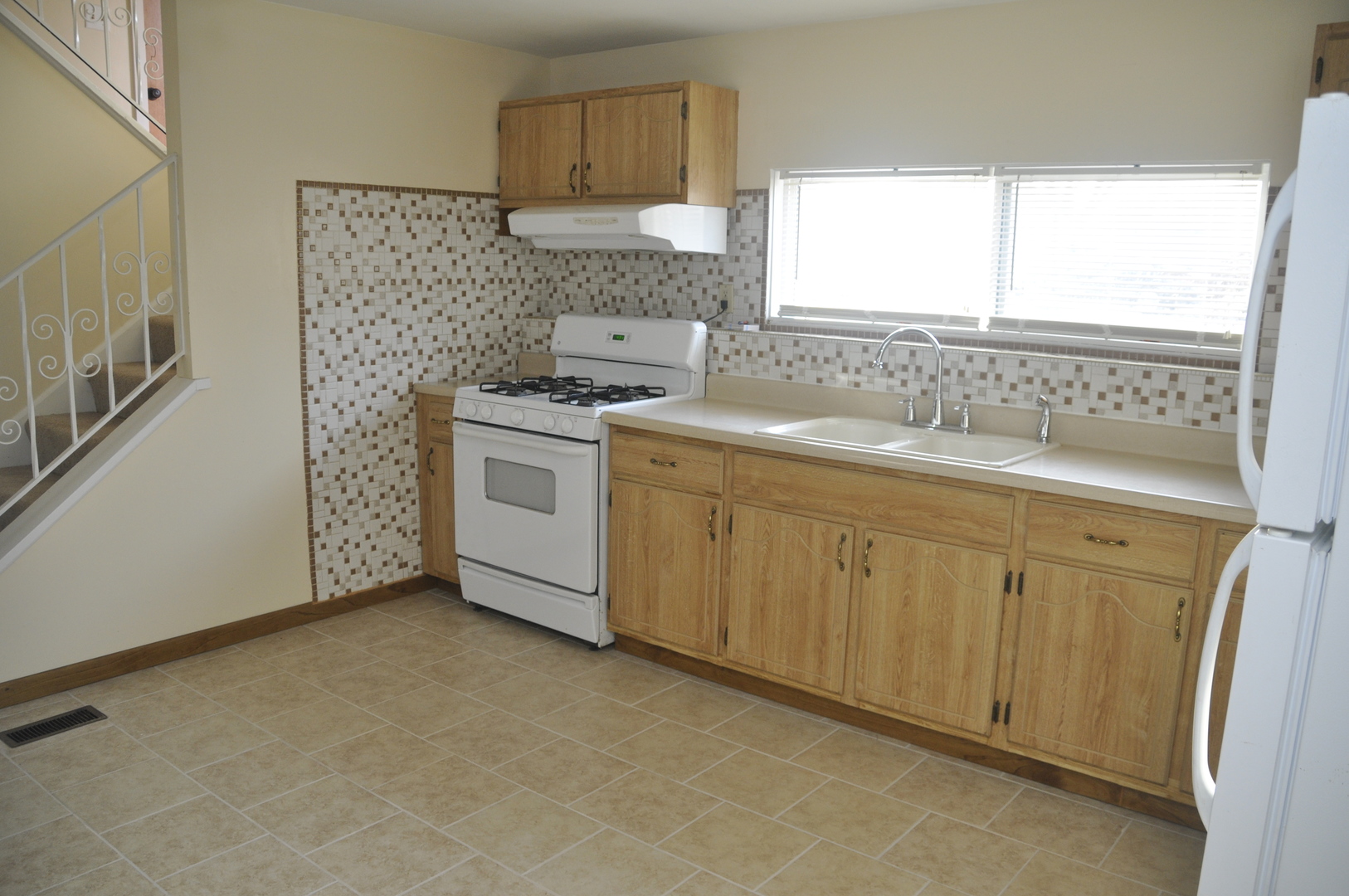 49 Pueblo Road Montgomery, IL 60538 - Photo 16 of 35 a kitchen with a sink stove and cabinets