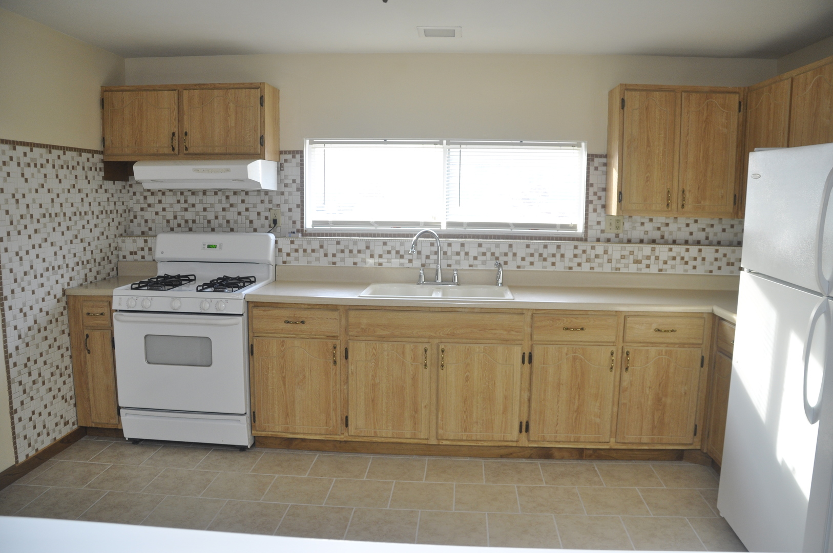 49 Pueblo Road Montgomery, IL 60538 - Photo 18 of 35 a kitchen with white cabinets and white appliances