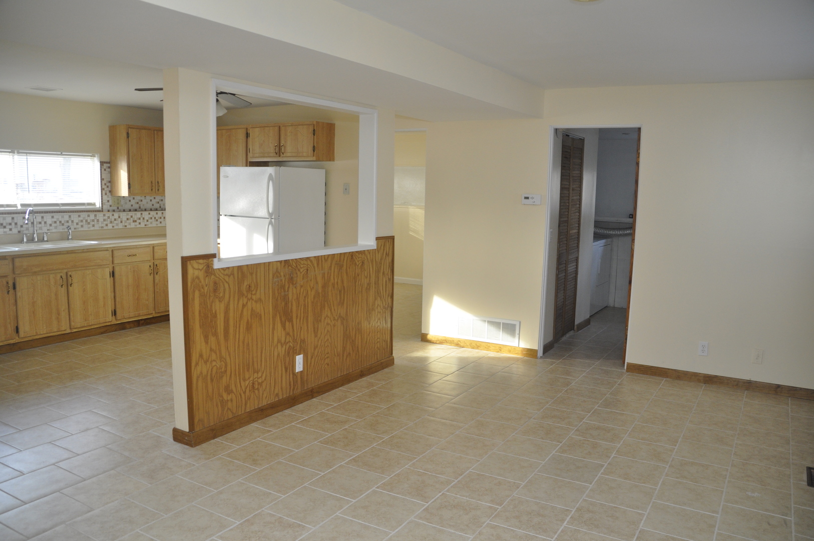 49 Pueblo Road Montgomery, IL 60538 - Photo 19 of 35 a view of an empty room with window and cabinet