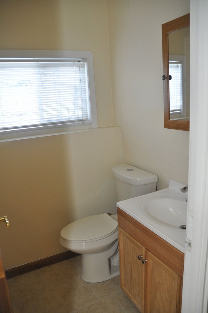 49 Pueblo Road Montgomery, IL 60538 - Photo 23 of 35 a white toilet sitting next to a bathroom sink