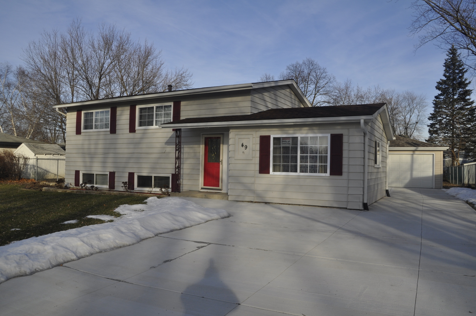 49 Pueblo Road Montgomery, IL 60538 - Photo 6 of 35 a front view of a house with a yard and garage