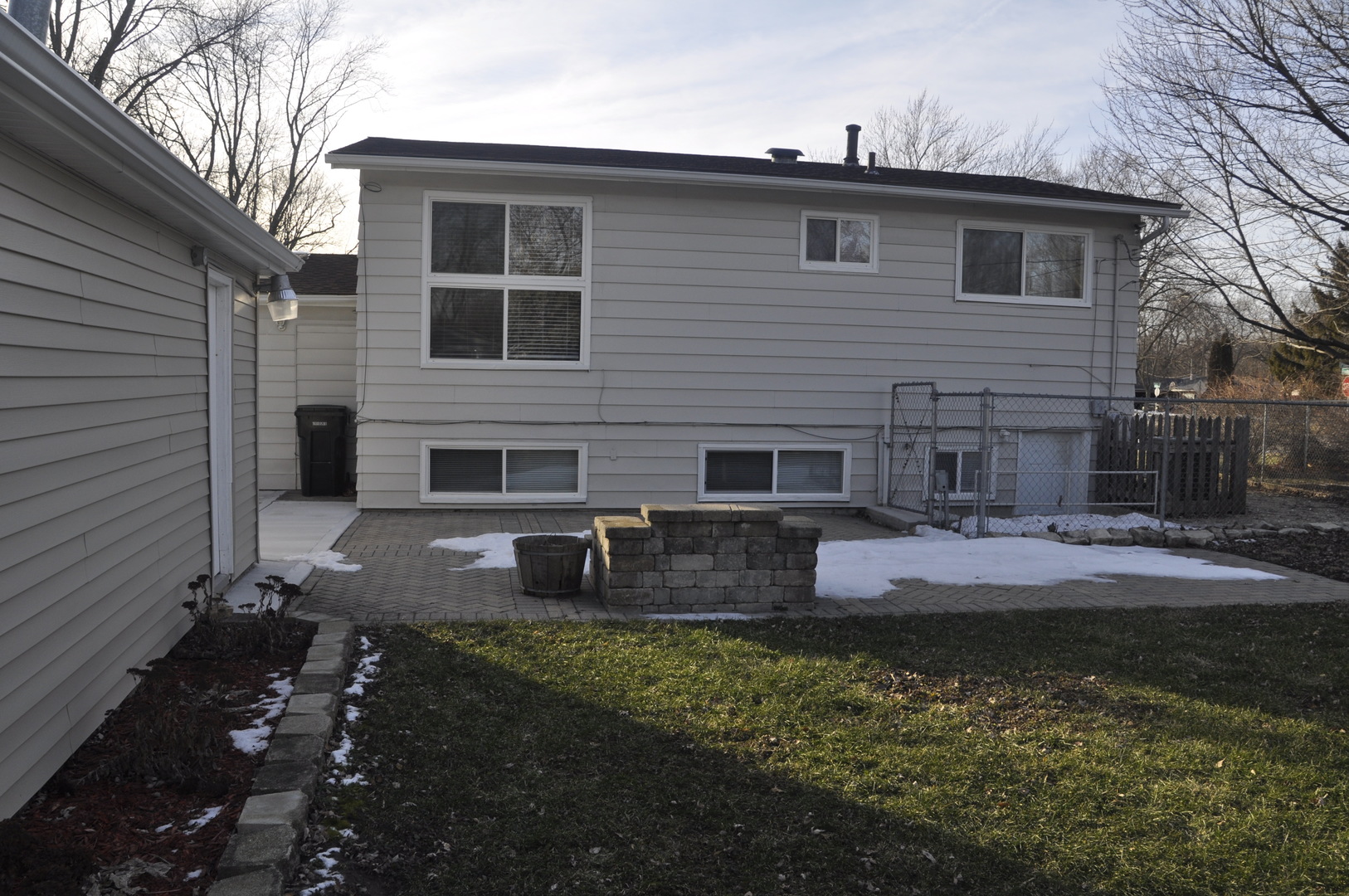 49 Pueblo Road Montgomery, IL 60538 - Photo 7 of 35 a front view of a house with garden and chairs