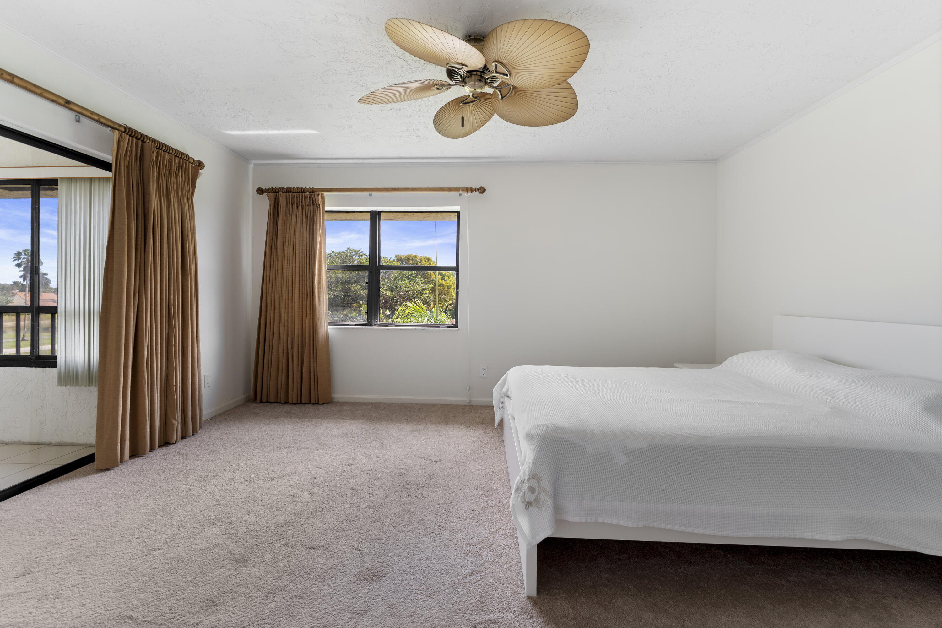 7507 La Paz Boulevard, Unit 407 Boca Raton, FL 33433 - Photo 13 of 31 a bedroom with a bed and window