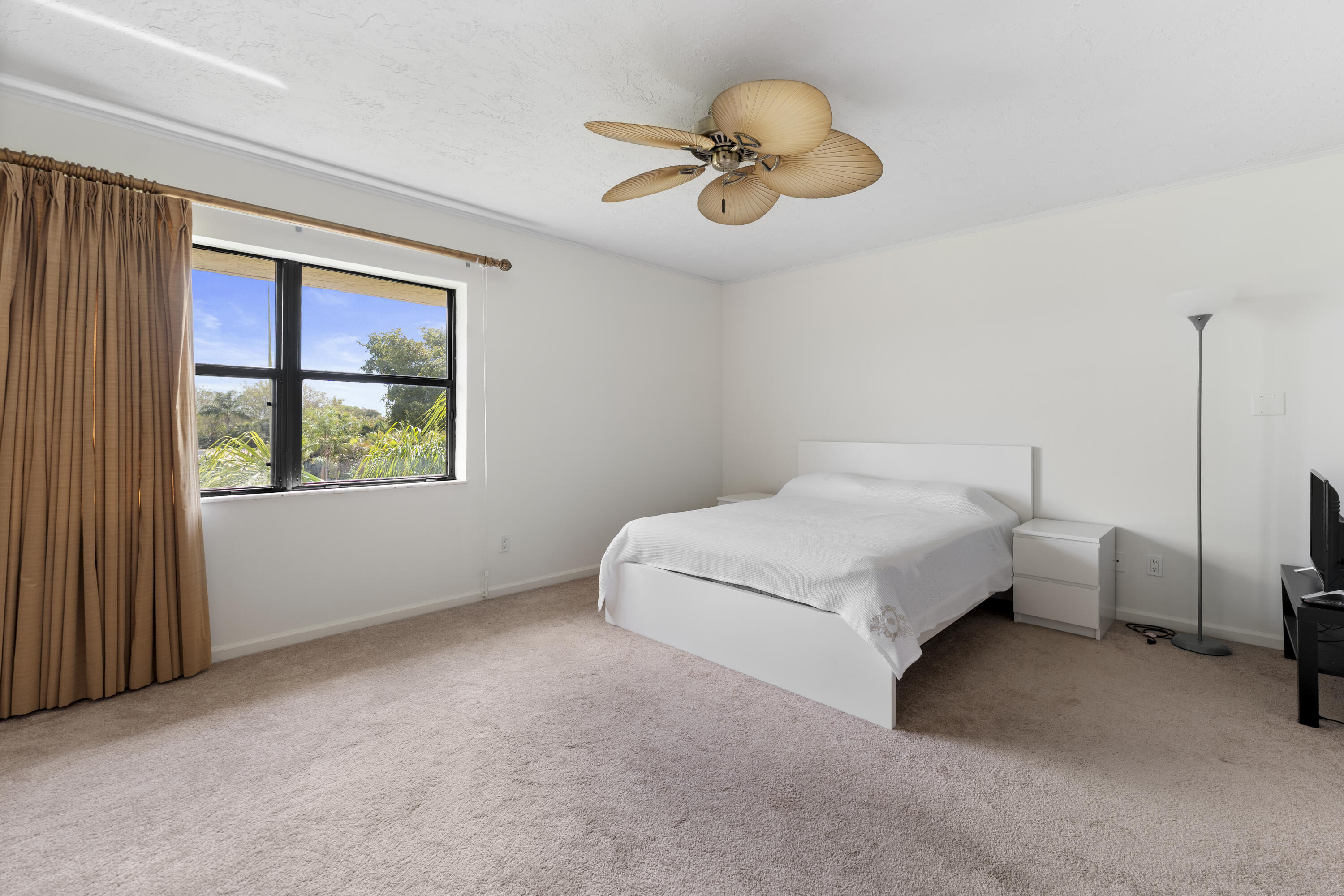 7507 La Paz Boulevard, Unit 407 Boca Raton, FL 33433 - Photo 14 of 31 a spacious bedroom with a bed and a window