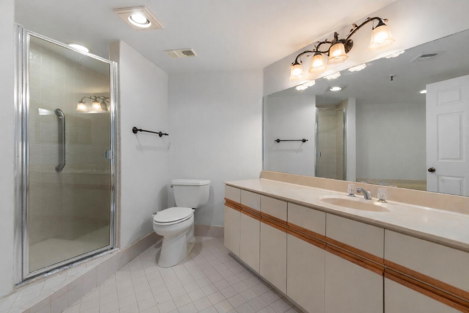7507 La Paz Boulevard, Unit 407 Boca Raton, FL 33433 - Photo 15 of 31 a bathroom with a sink a toilet and shower