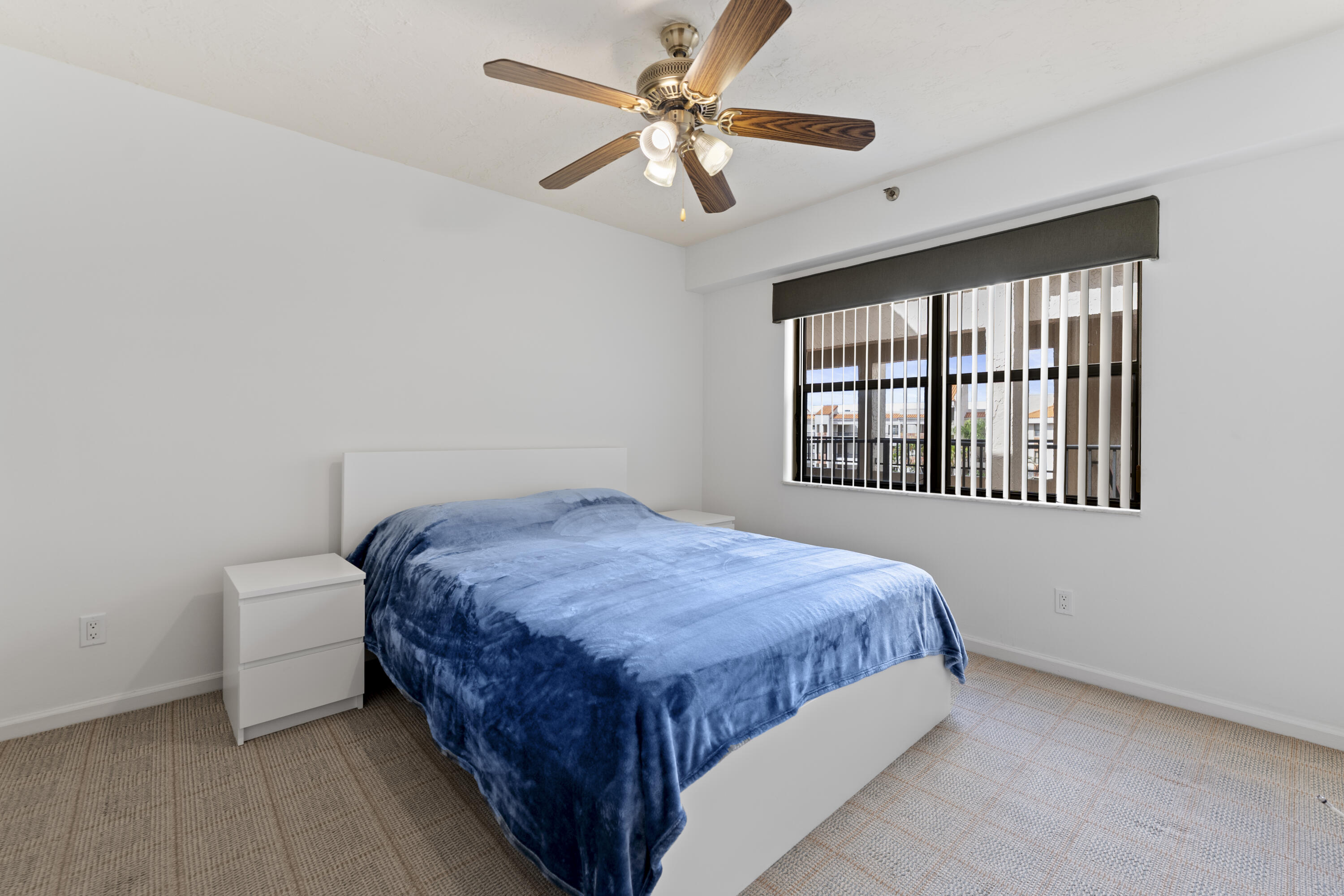 7507 La Paz Boulevard, Unit 407 Boca Raton, FL 33433 - Photo 17 of 31 a bedroom with a bed and a window