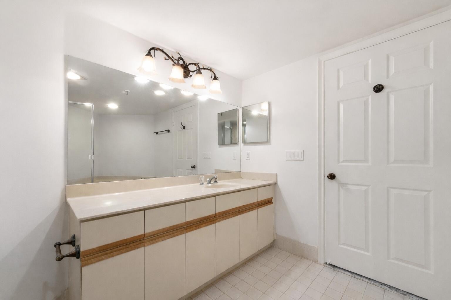 7507 La Paz Boulevard, Unit 407 Boca Raton, FL 33433 - Photo 20 of 31 a room with a sink and a mirror