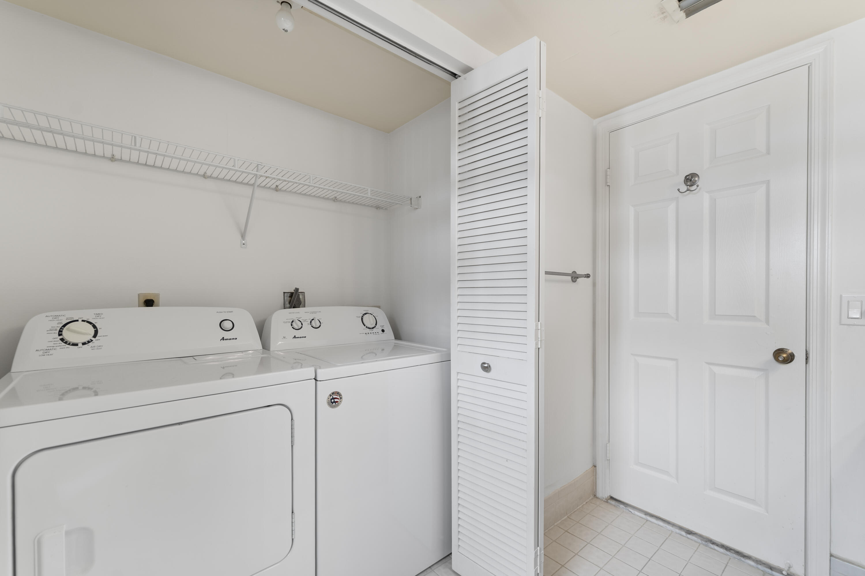 7507 La Paz Boulevard, Unit 407 Boca Raton, FL 33433 - Photo 23 of 31 a view of storage and utility room with washer and dryer