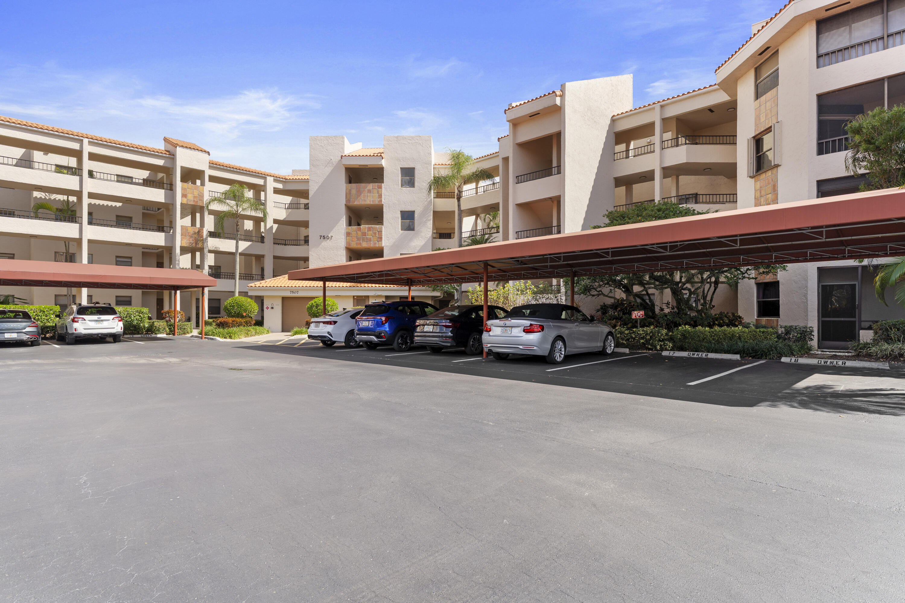 7507 La Paz Boulevard, Unit 407 Boca Raton, FL 33433 - Photo 3 of 31 a car parked in front of a building