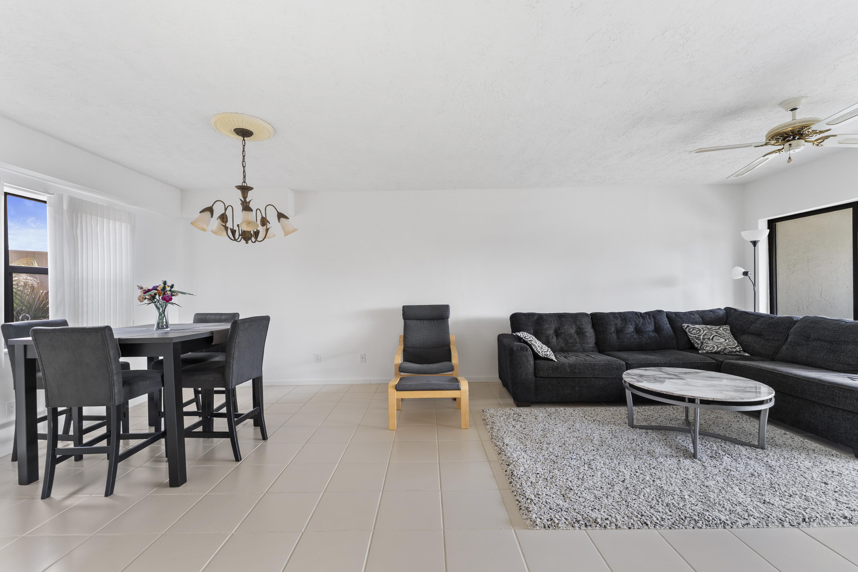 7507 La Paz Boulevard, Unit 407 Boca Raton, FL 33433 - Photo 7 of 31 a living room with furniture and wooden floor