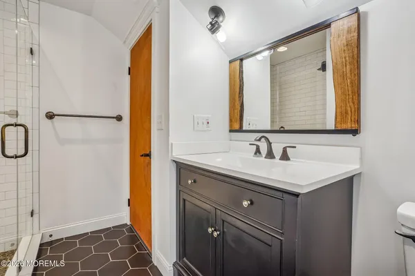 a bathroom with a shower and a sink