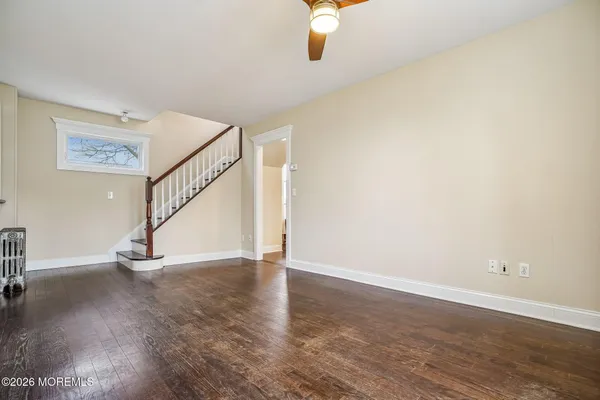 wooden floor in an empty room with a window