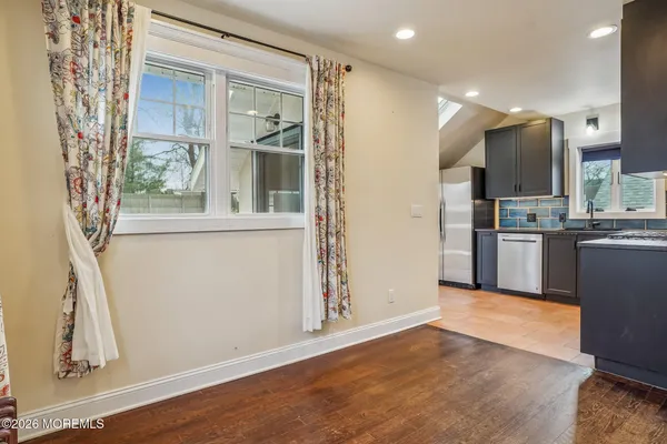 a kitchen with a refrigerator sink and cabinets