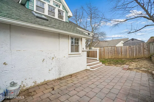 a view of a backyard with table and chairs